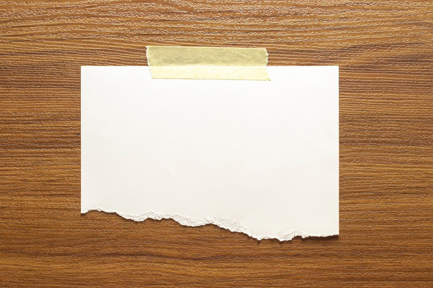 blank-torn-paper-frame-glued-with-adhesive-tape-to-wooden-textured-wall
