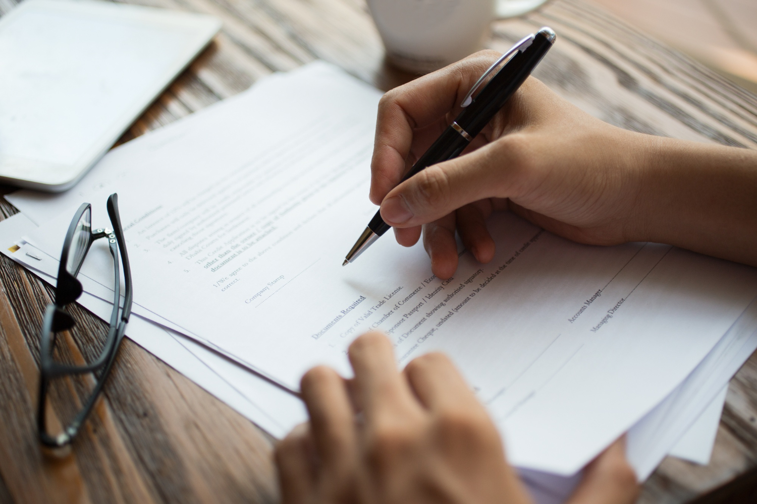 businessman-examining-papers-at-table